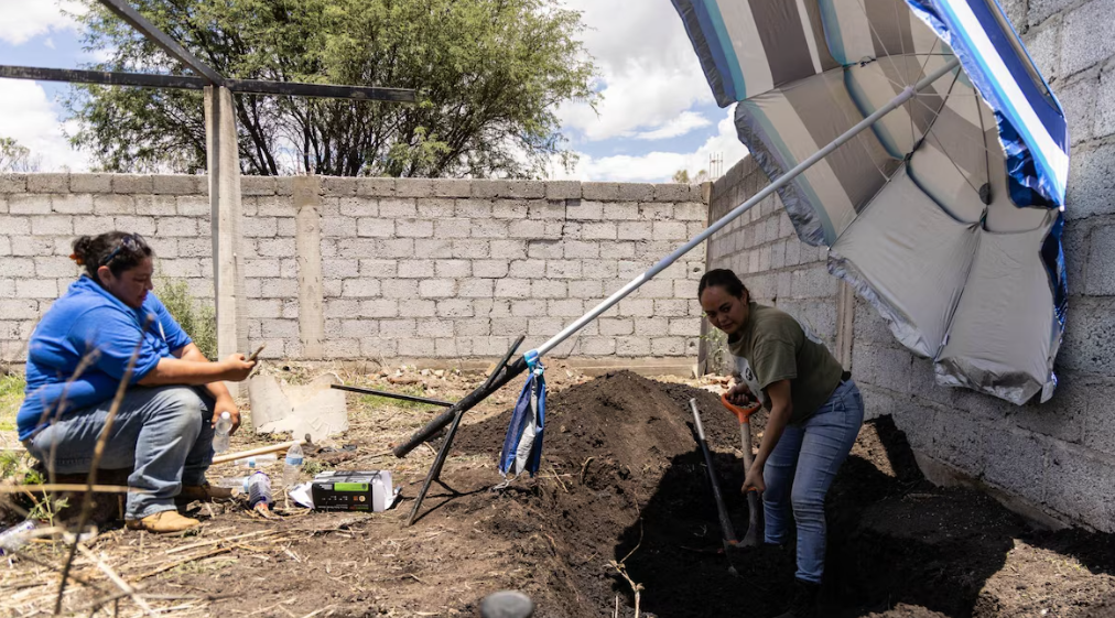 Personal forense realiza la inhumación de cuerpos no identificados.